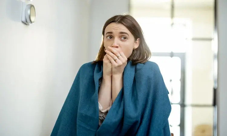 Chronic Bad Breath Root Causes Guide Woman wrapped in a blue blanket whit Chronic Bad Breath